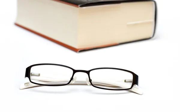 Livro grosso e óculos — Fotografia de Stock