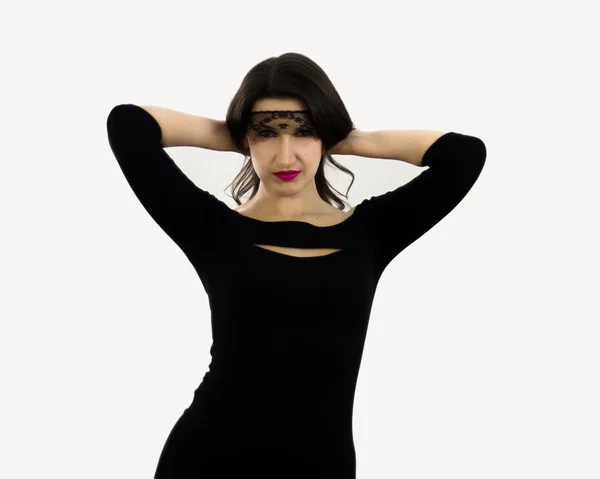 Femme fatale in a black dress and mask — Stock Photo, Image