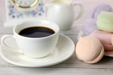 a cup of coffee and colorful natural delicious marshmallows for breakfast