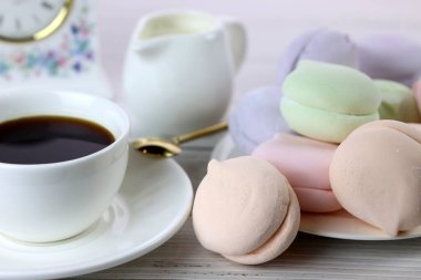 a cup of coffee and colorful natural delicious marshmallows for breakfast