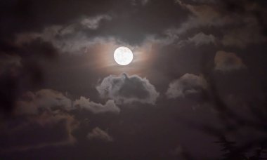 Gökyüzünde dolunay bulutlarla kaplı.