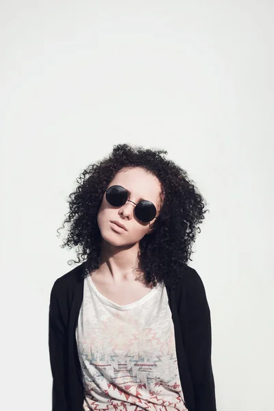 Young beautiful girl with curly hair in circle glasses — Stock Photo, Image