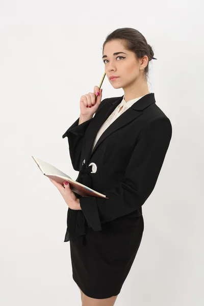 Hermosa mujer de negocios sobre un fondo blanco con bloc de notas — Foto de Stock