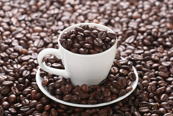 Cup with coffee beans — Stock Photo, Image