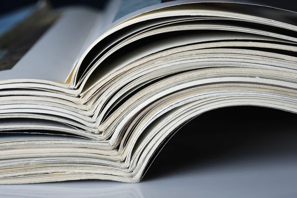 Pile of old magazines with bending pages. — Stock Photo, Image