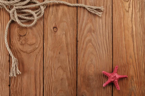 Rope shells starfish on wooden boards — Stock Photo, Image