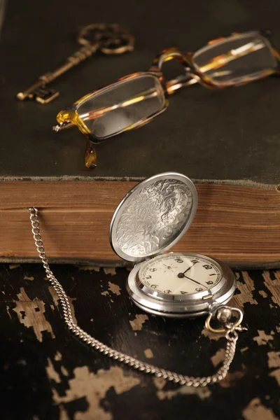 Vintage pocket watch old book and brass key — Stock Photo, Image