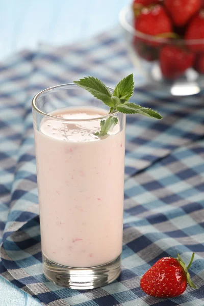 Strawberry with yogurt in a glass on a wooden background — Stock Photo, Image