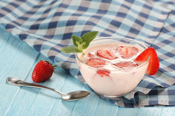 Strawberry with yogurt in a glass bowl on a wooden board — Stock Photo, Image