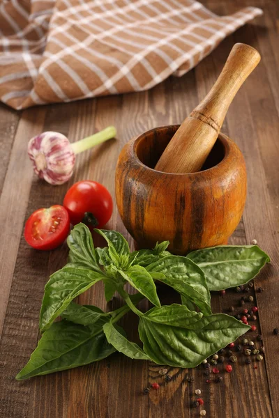 Fresh basil, tomato, garlic, wooden mortar — Stock Photo, Image