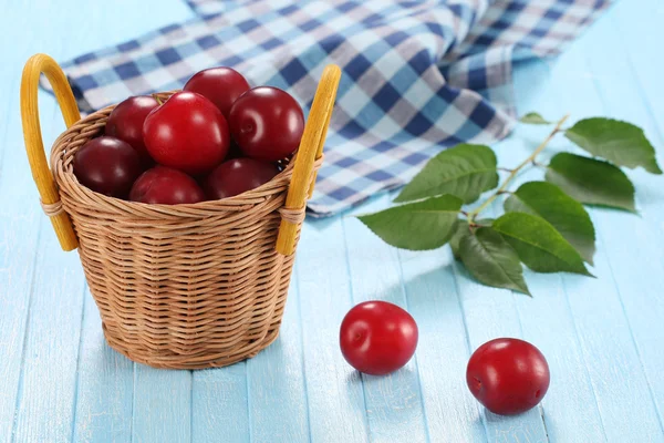 Fresh plums in a wicker basket — Stock Photo, Image