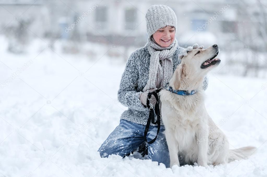 Portrait of a boy with a dog on a winter day