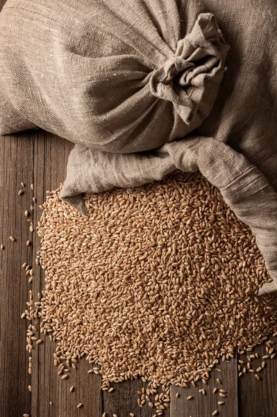 Sacks of grain on old boards — Stock Photo, Image