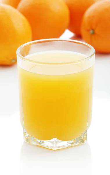 Orange juice and oranges — Stock Photo, Image