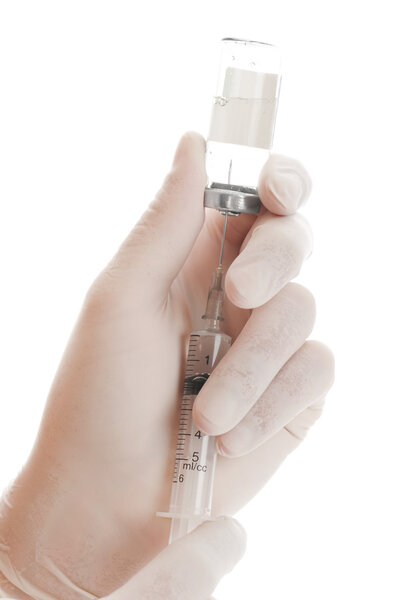 Filling of a syringe by a medicine from vial the person in gloves
