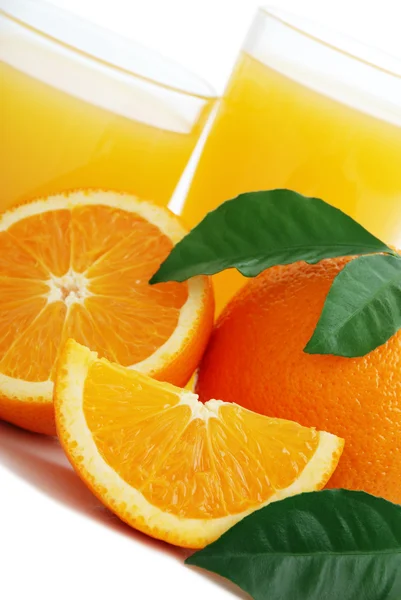 Orange juice and oranges — Stock Photo, Image