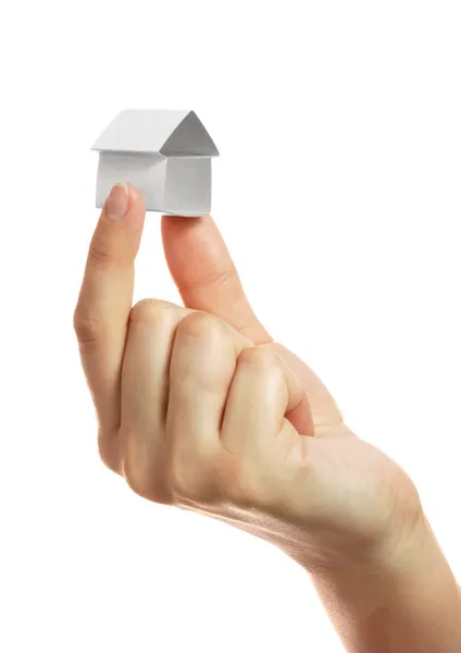 Small house from a paper in a hand — Stock Photo, Image