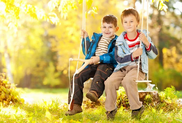 Boys on swing — Stock Photo, Image