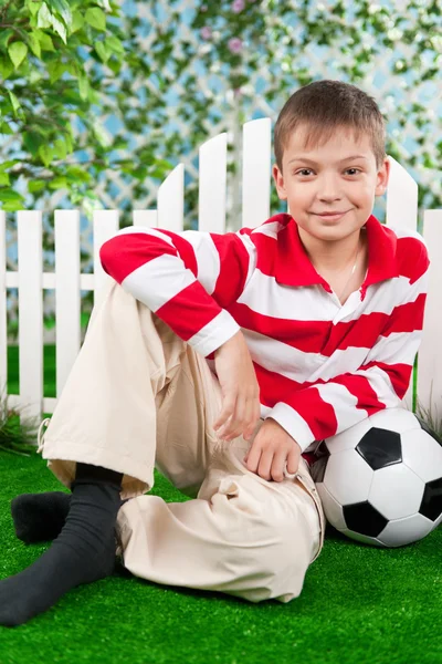 Kleine jongen op het gras met de bal — Stockfoto