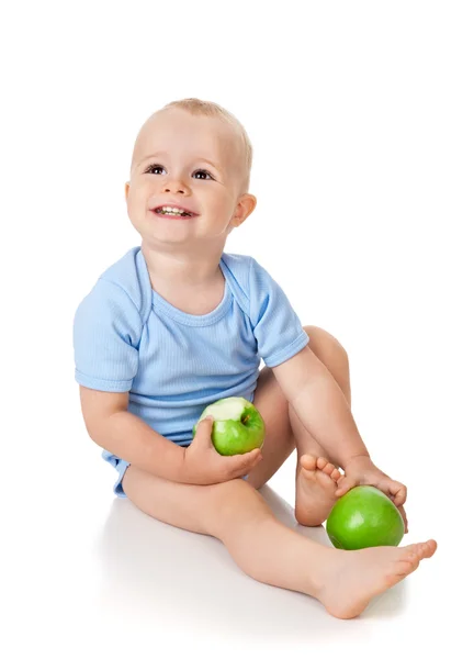 O menino come uma maçã verde — Fotografia de Stock
