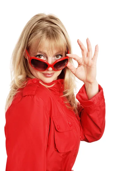 Woman in red coat  and solar glasses — Stock Photo, Image