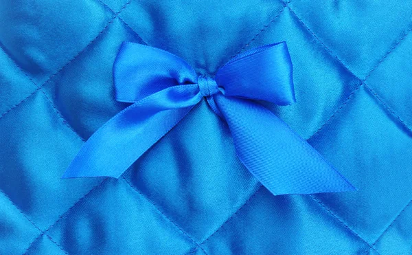 Blue silk background with a bow — Stock Photo, Image