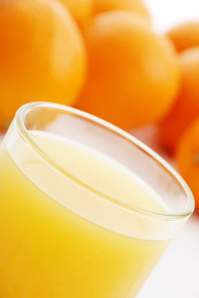 Orange juice and oranges — Stock Photo, Image