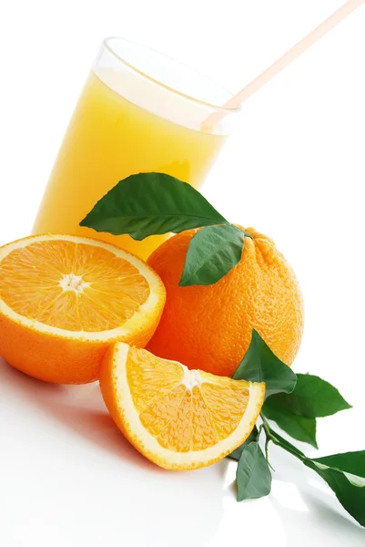 Orange juice and oranges — Stock Photo, Image