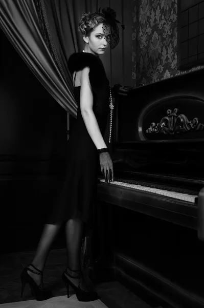Κορίτσι σε ρετρό στυλ που κοντά πιάνο — Φωτογραφία Αρχείου