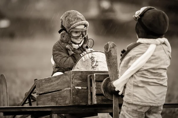 Aviators with handmade airplane — Stock Photo, Image