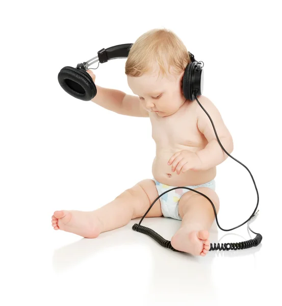 El pequeño bebé en auriculares —  Fotos de Stock