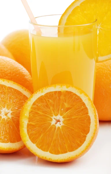 Orange juice and oranges — Stock Photo, Image