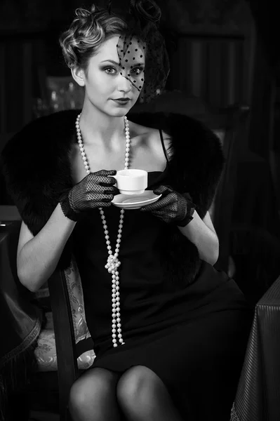 Girl in retro style with cup of tea