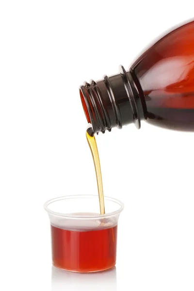 The person pours a syrup in a spoon — Stock Photo, Image