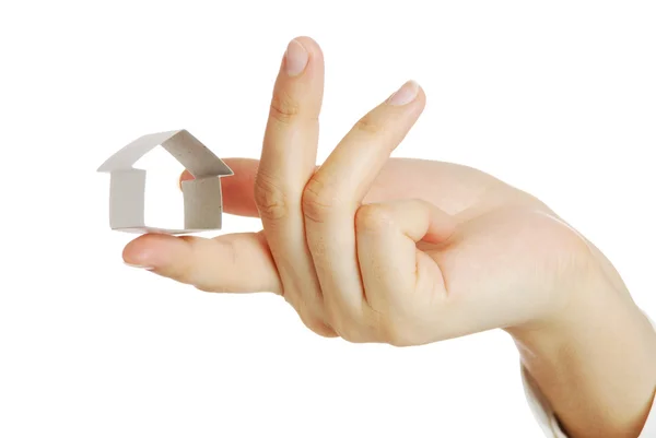 Small house from a paper in a hand — Stock Photo, Image