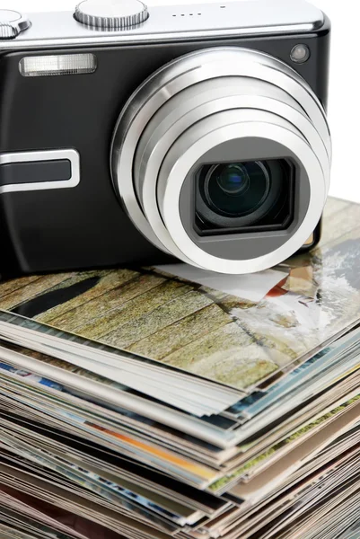 Digital camera and the heap of photos — Stock Photo, Image