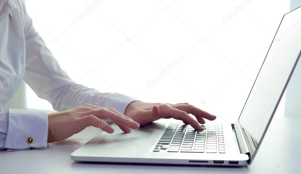 Business woman typing on a laptop