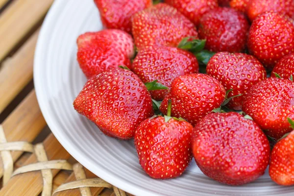 Strawberry in a disk on bamboo table — Stock Photo, Image