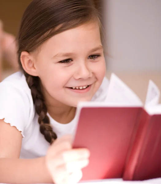 Little girl is reading a book — Stock Photo, Image