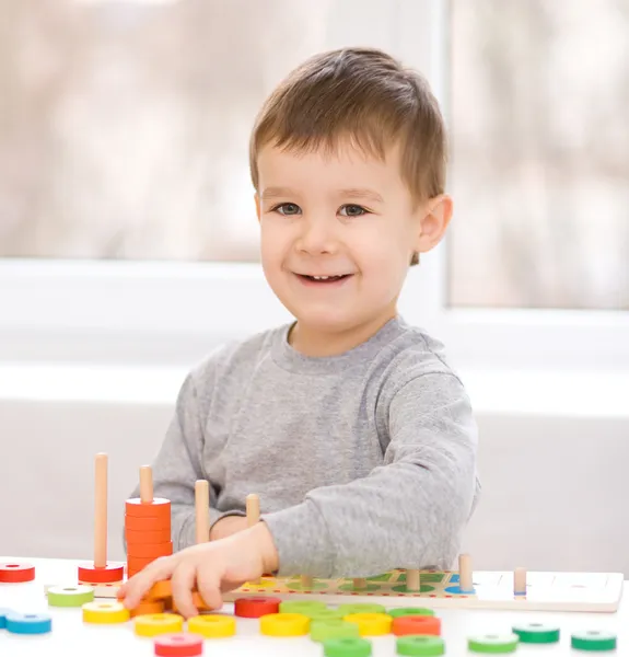 Boy is playing with building blocks — Stock Photo, Image