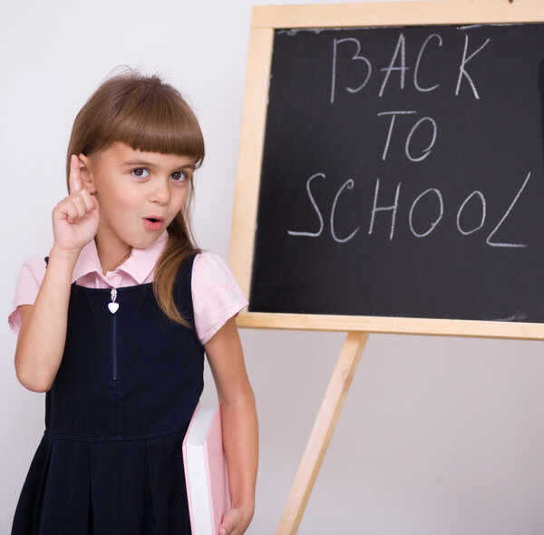Cute girl is holding book