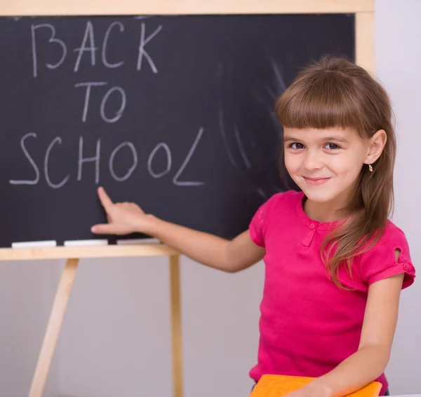 Cute girl is holding book — Stock Photo, Image