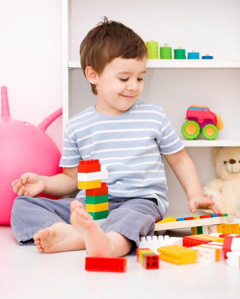 Boy is playing with building blocks