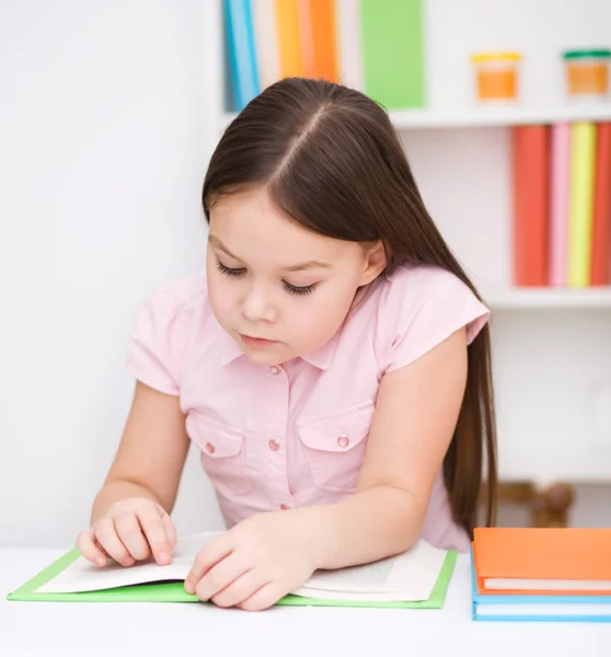 Liten flicka läser en bok — Stockfoto