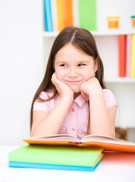 Little girl is reading a book Stock Image