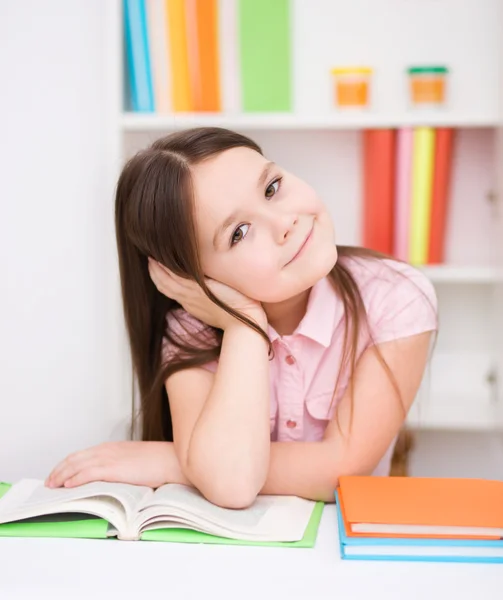 Little girl is reading a book Stock Picture