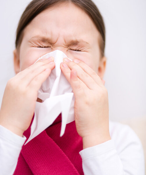 Girl is blowing her nose