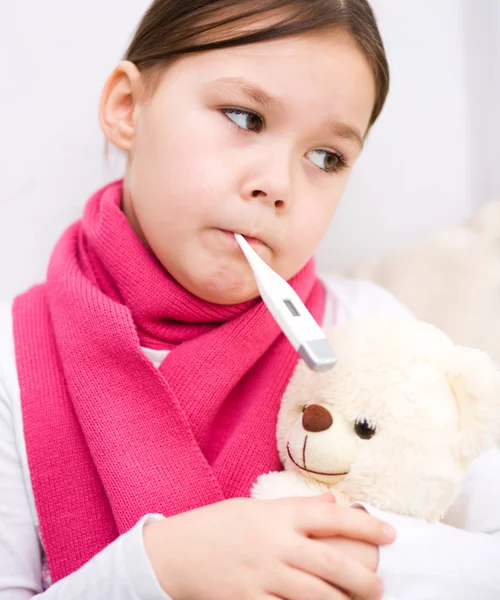 Little girl with thermometer in her mouth Royalty Free Stock Images