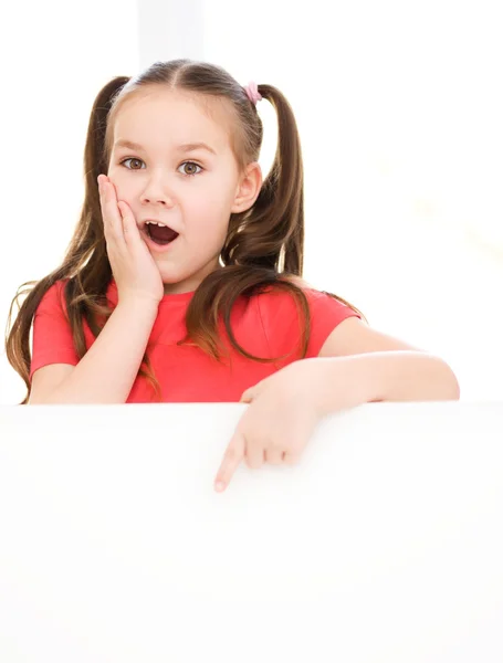 Cute girl is holding blank banner — Stock Photo, Image