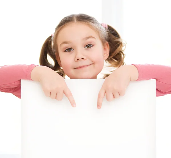 Cute girl is holding blank banner — Stock Photo, Image